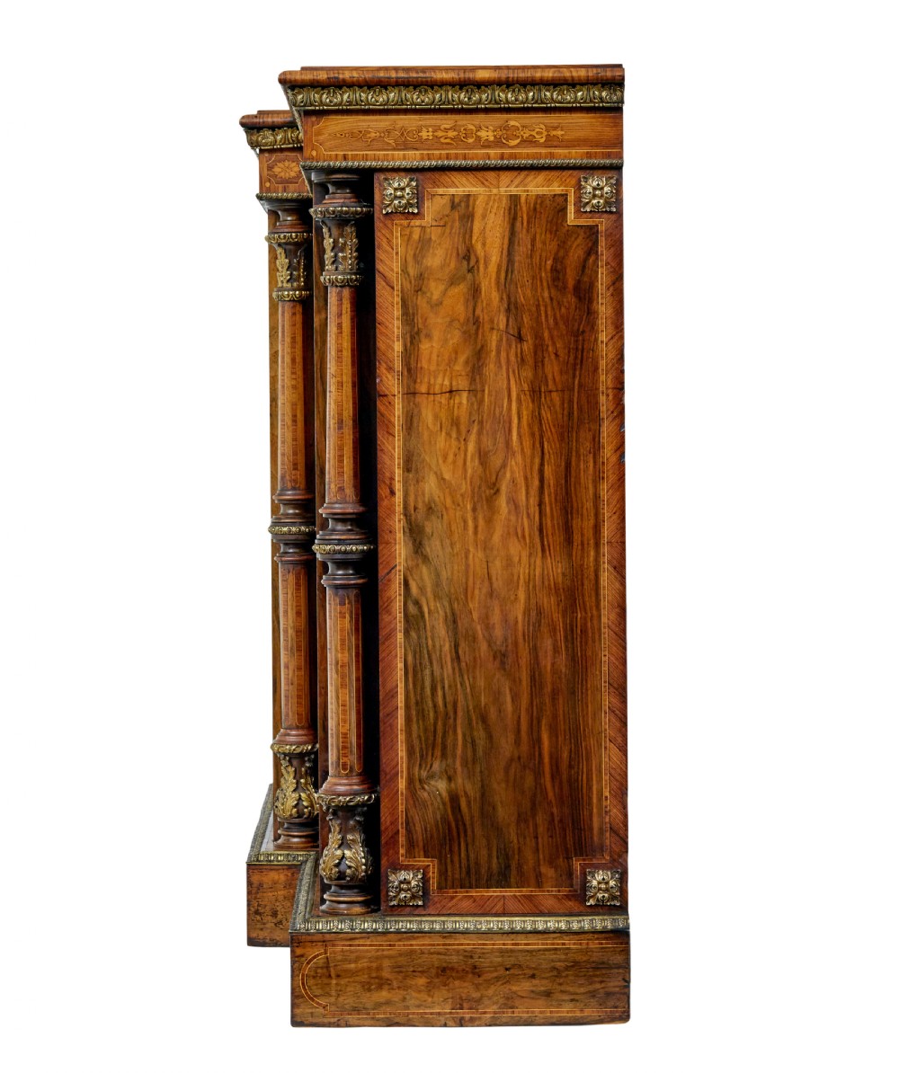 A mid-19th century Victorian walnut credenza featuring three glass-fronted doors, intricate marquetry inlay, and ornate gilt-bronze mounts. View V