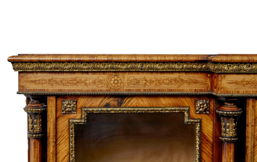 A mid-19th century Victorian walnut credenza featuring three glass-fronted doors, intricate marquetry inlay, and ornate gilt-bronze mounts. View VII