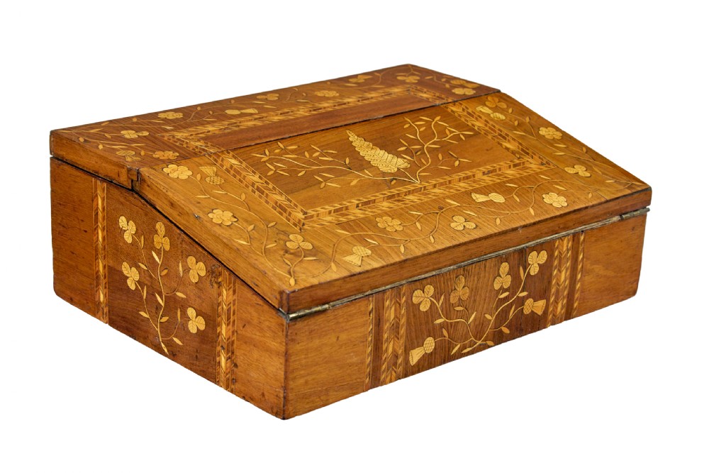 A 19th-century wooden writing slope decorated with marquetry inlays of shamrocks and botanical motifs across the sloped lid.