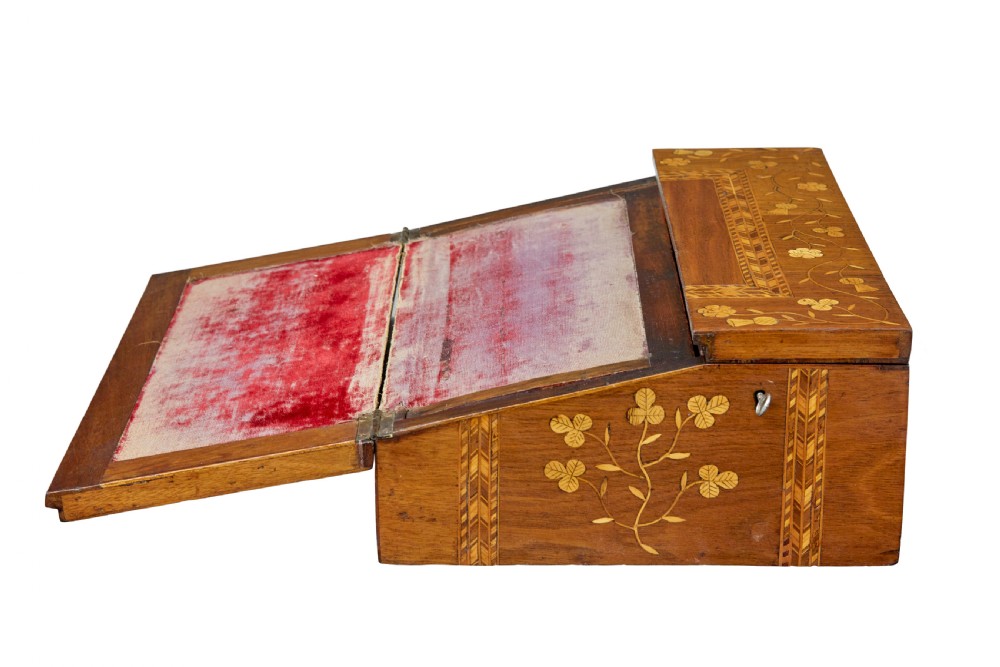A 19th-century wooden writing slope decorated with marquetry inlays of shamrocks and botanical motifs across the sloped lid. View V
