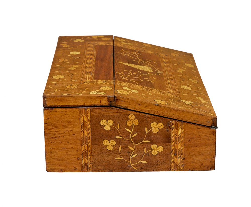 A 19th-century wooden writing slope decorated with marquetry inlays of shamrocks and botanical motifs across the sloped lid. View VI