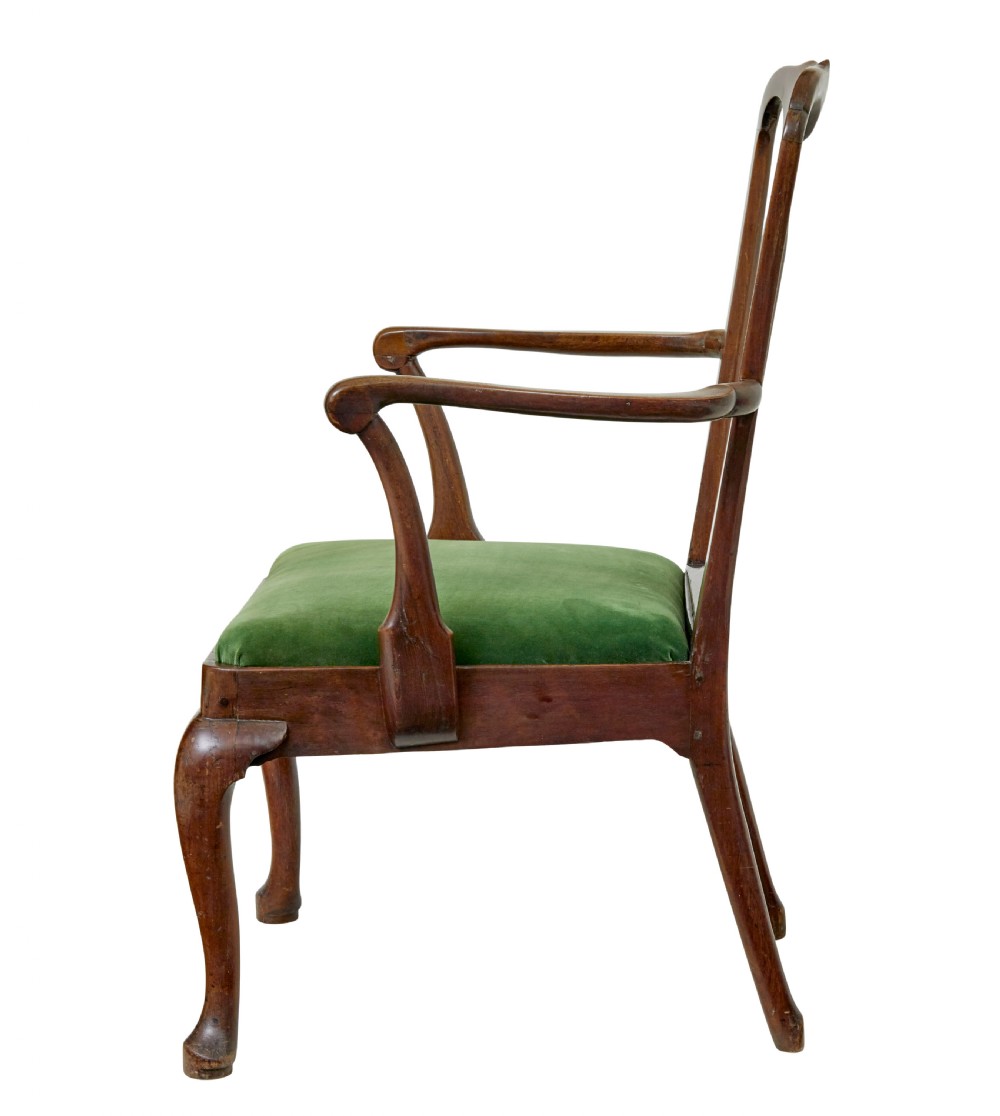 An 18th-century walnut open armchair featuring a contoured vase splat back, curved arms, a green velvet seat, and front cabriole legs with pad feet. View III