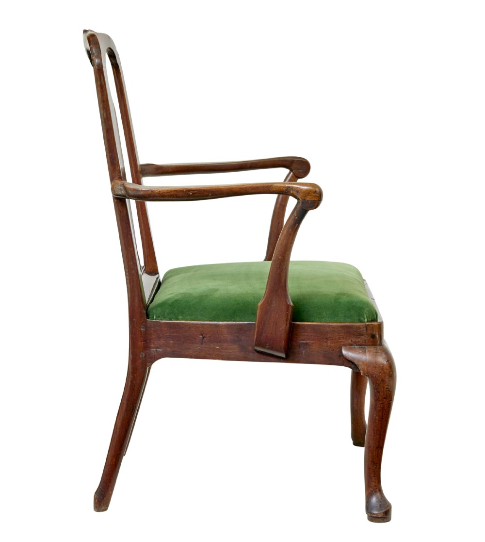 An 18th-century walnut open armchair featuring a contoured vase splat back, curved arms, a green velvet seat, and front cabriole legs with pad feet. View IV