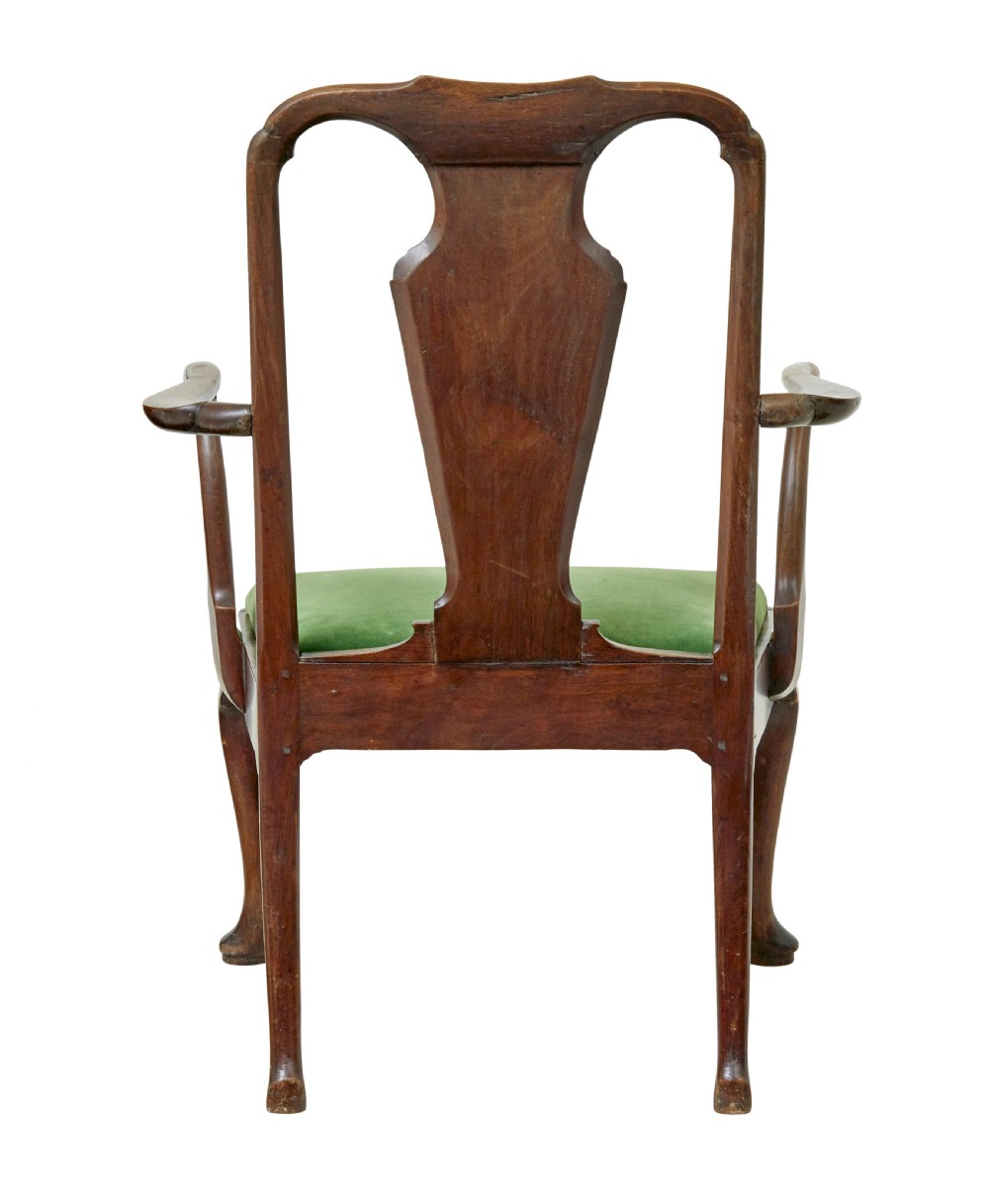 An 18th-century walnut open armchair featuring a contoured vase splat back, curved arms, a green velvet seat, and front cabriole legs with pad feet. View V