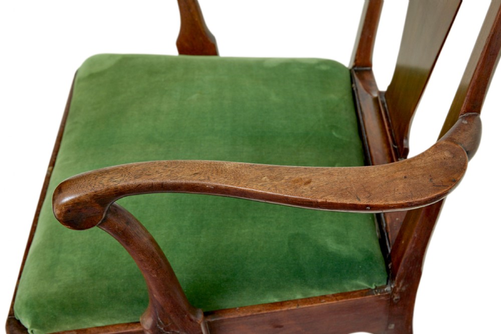 An 18th-century walnut open armchair featuring a contoured vase splat back, curved arms, a green velvet seat, and front cabriole legs with pad feet. View VI