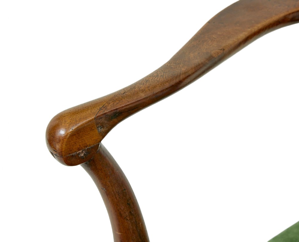An 18th-century walnut open armchair featuring a contoured vase splat back, curved arms, a green velvet seat, and front cabriole legs with pad feet. View IX