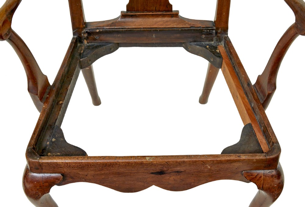 An 18th-century walnut open armchair featuring a contoured vase splat back, curved arms, a green velvet seat, and front cabriole legs with pad feet. View X