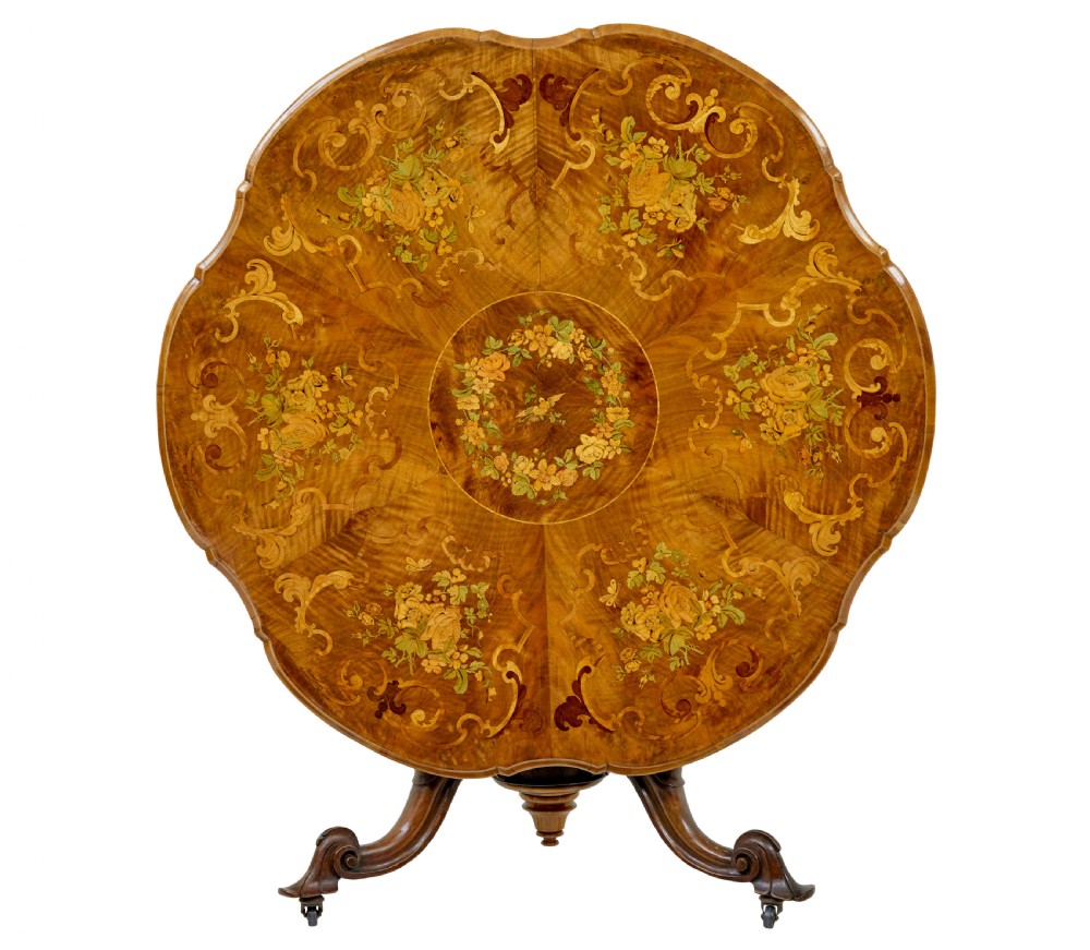 A 19th-century Victorian walnut centre table featuring intricate floral marquetry inlays, a shaped rim, and a carved central pedestal with four scroll legs on castors. View IV