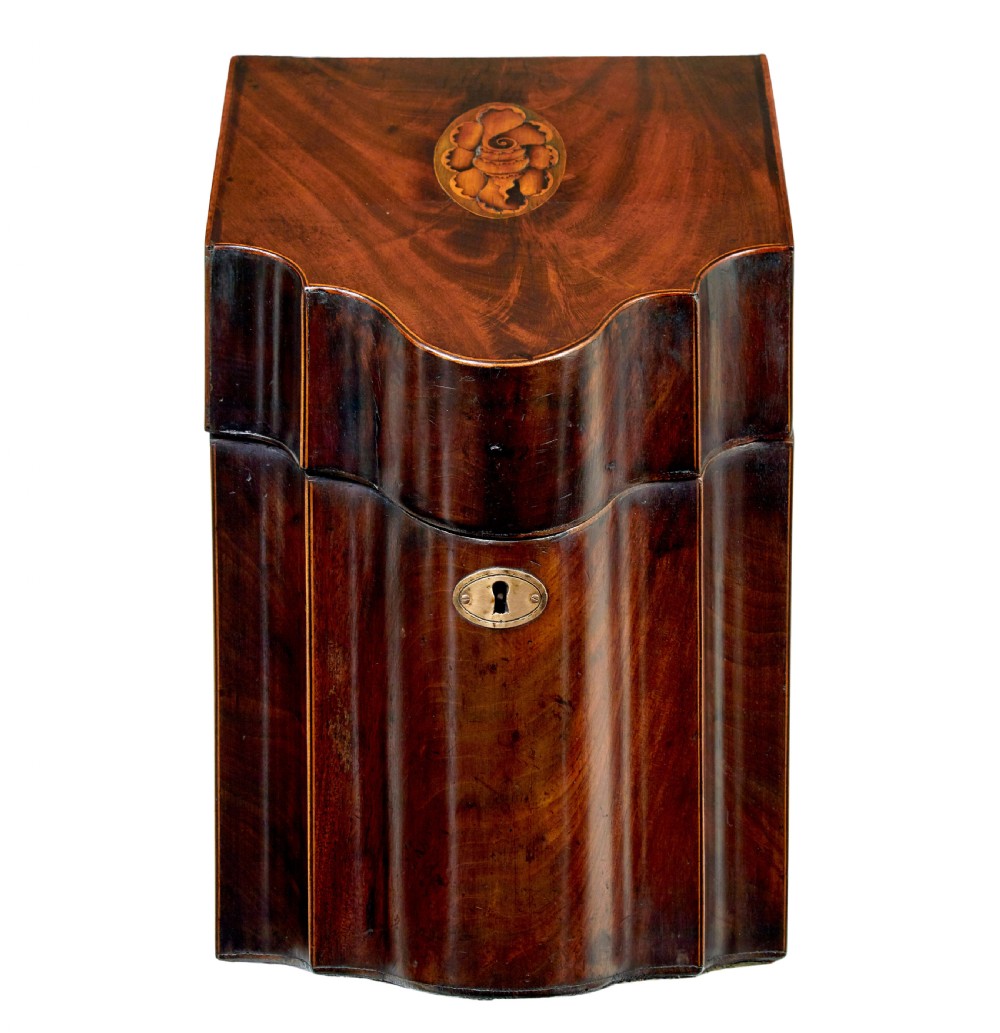 An 18th-century Georgian mahogany knife box featuring a sloping lid with a central floral marquetry inlay, serpentine front profile, and brass keyhole escutcheon.