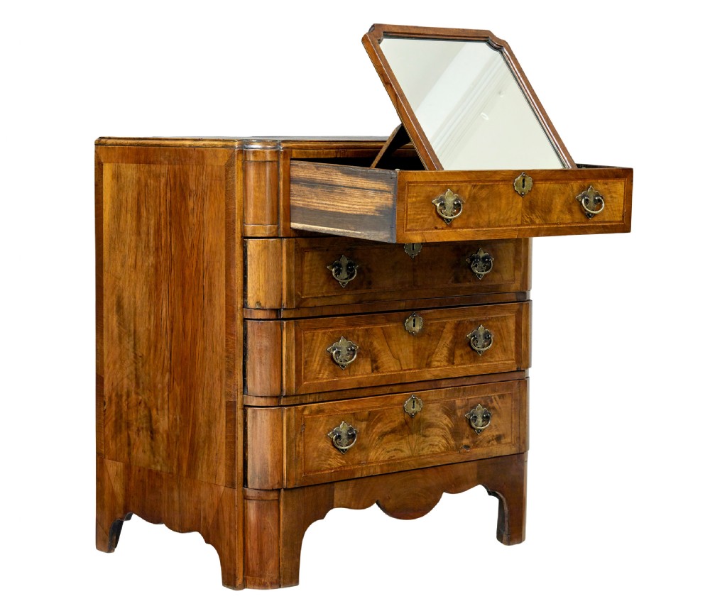 A four-drawer walnut chest featuring figured wood veneers, shaped bottom apron, brass handles, and rounded front corners. View VIII