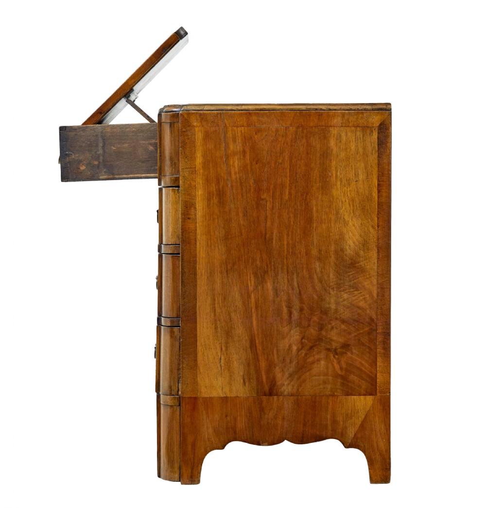 A four-drawer walnut chest featuring figured wood veneers, shaped bottom apron, brass handles, and rounded front corners. View XIII