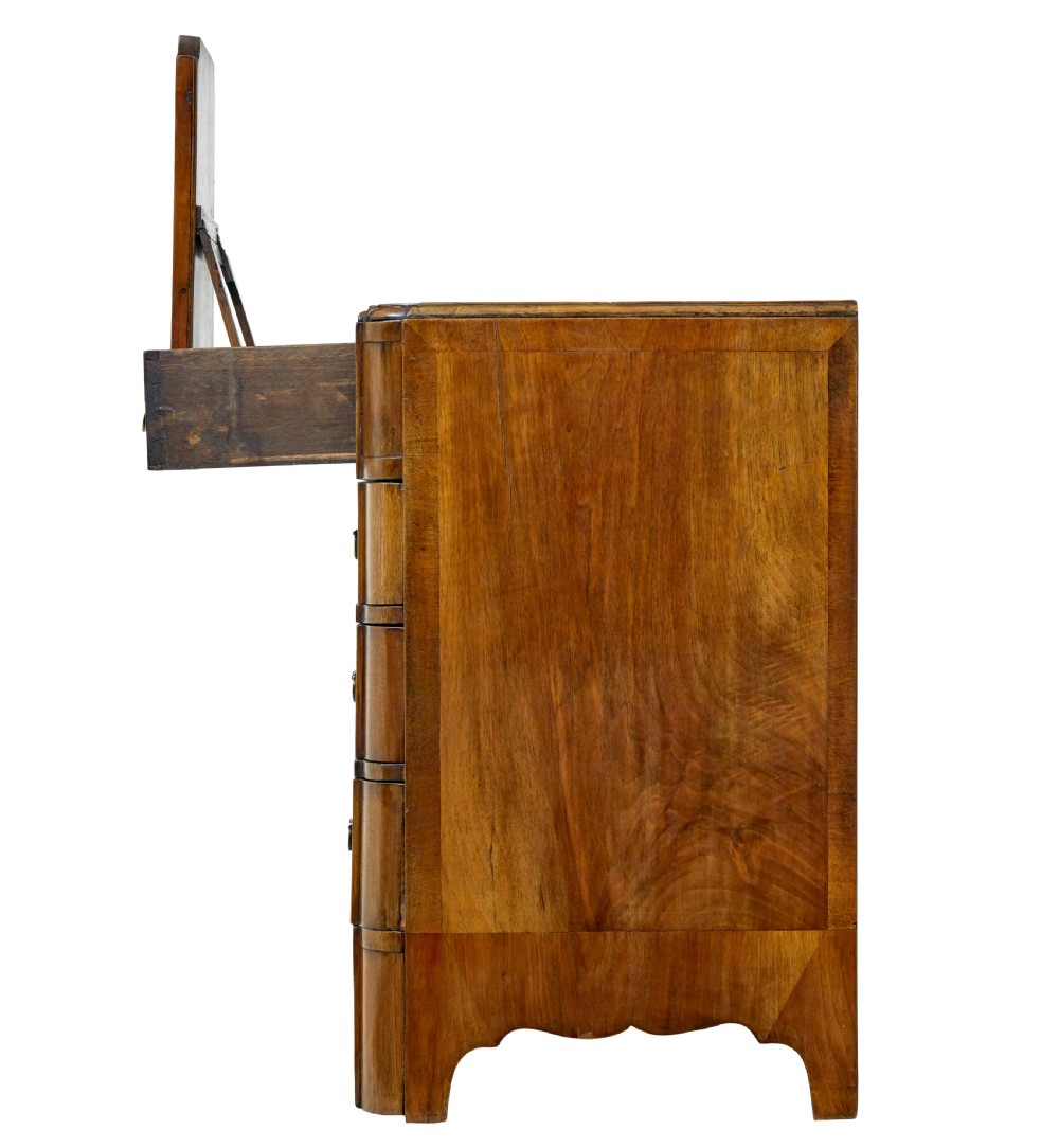 A four-drawer walnut chest featuring figured wood veneers, shaped bottom apron, brass handles, and rounded front corners. View XIV