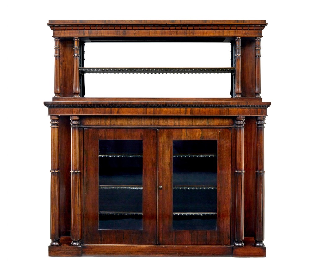 A mid 19th-century dark palisander wood chiffonier with turned columns, glazed cabinet doors, and an upper display shelf structure with mirror backing.
