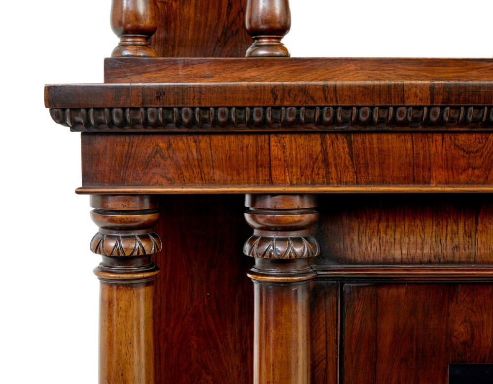 A mid 19th-century dark palisander wood chiffonier with turned columns, glazed cabinet doors, and an upper display shelf structure with mirror backing. View VII