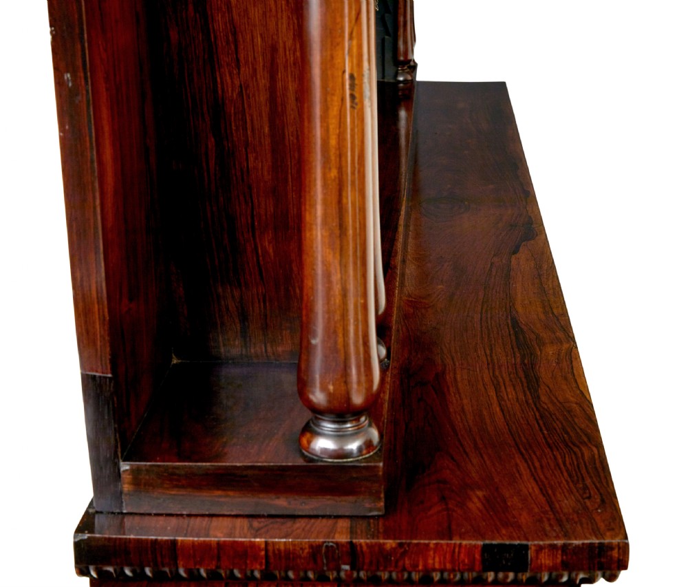 A mid 19th-century dark palisander wood chiffonier with turned columns, glazed cabinet doors, and an upper display shelf structure with mirror backing. View IX
