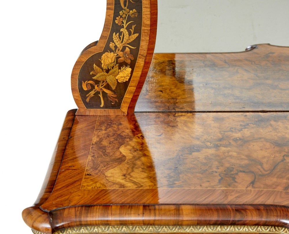 A High Victorian burr walnut credenza featuring floral marquetry inlay, glazed side display cabinets, gilt metal mounts, and a shaped mirror frame superstructure. View XII