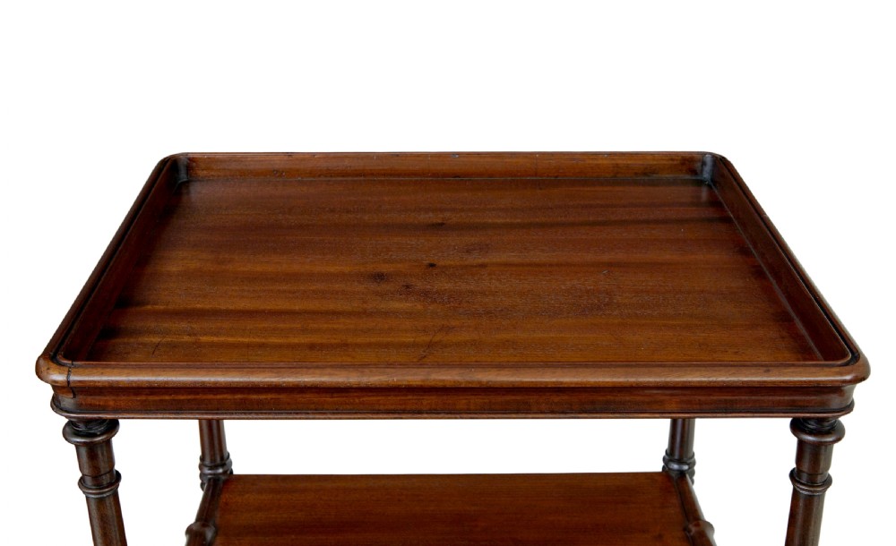 A mid-19th-century mahogany four-tier whatnot featuring slender turned supports, a single base drawer with turned wooden handles, and turned legs with brass castors. View VII