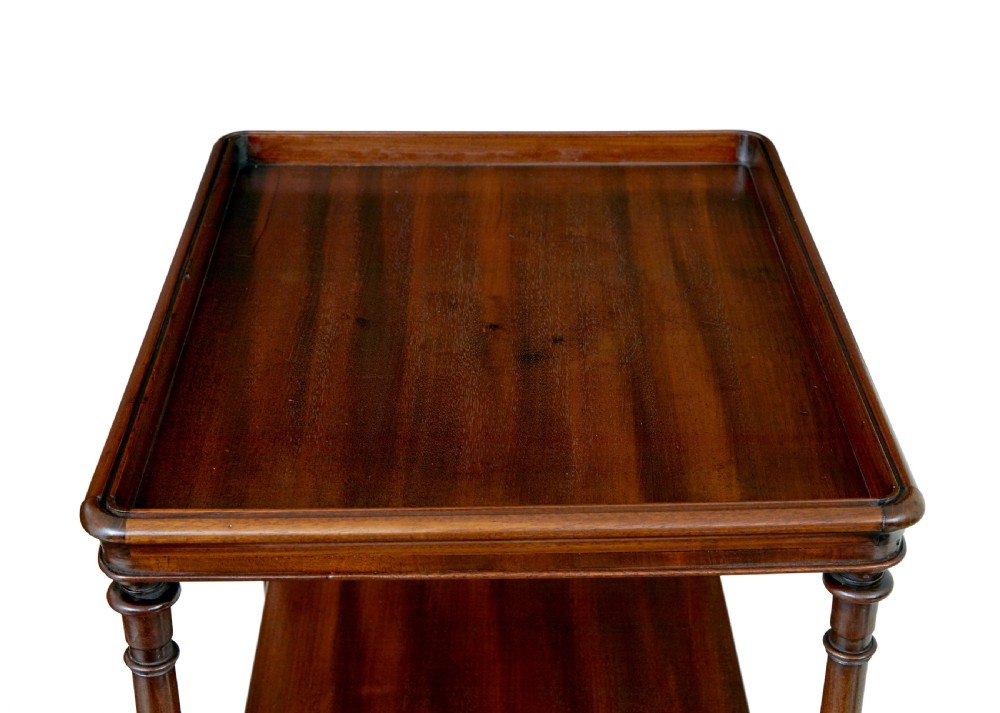 A mid-19th-century mahogany four-tier whatnot featuring slender turned supports, a single base drawer with turned wooden handles, and turned legs with brass castors. View VIII