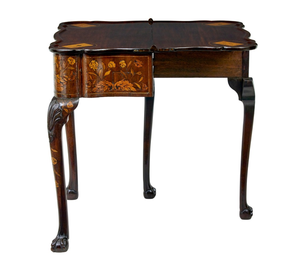 An 18th-century Dutch walnut games table decorated with floral marquetry inlay, carved cabriole legs, and brass drop handles. View III
