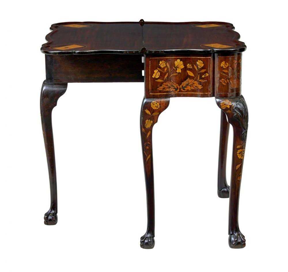 An 18th-century Dutch walnut games table decorated with floral marquetry inlay, carved cabriole legs, and brass drop handles. View V