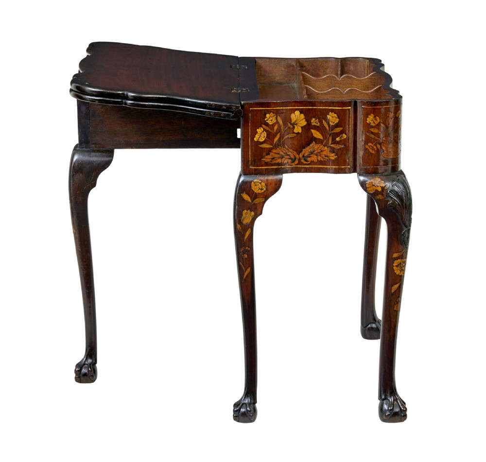 An 18th-century Dutch walnut games table decorated with floral marquetry inlay, carved cabriole legs, and brass drop handles. View VI