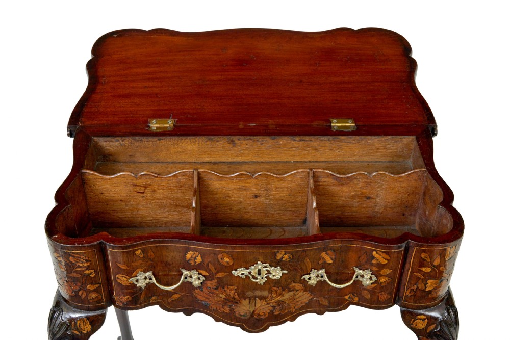 An 18th-century Dutch walnut games table decorated with floral marquetry inlay, carved cabriole legs, and brass drop handles. View VII