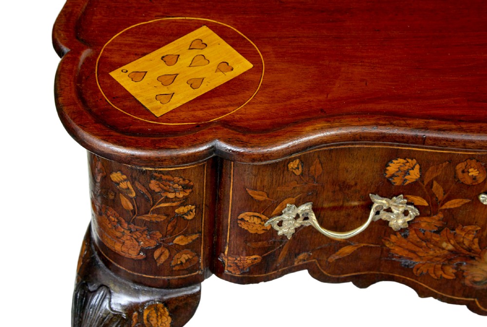 An 18th-century Dutch walnut games table decorated with floral marquetry inlay, carved cabriole legs, and brass drop handles. View IX