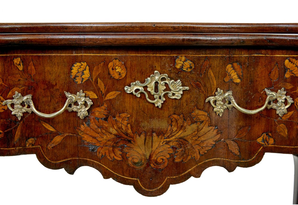 An 18th-century Dutch walnut games table decorated with floral marquetry inlay, carved cabriole legs, and brass drop handles. View XIII