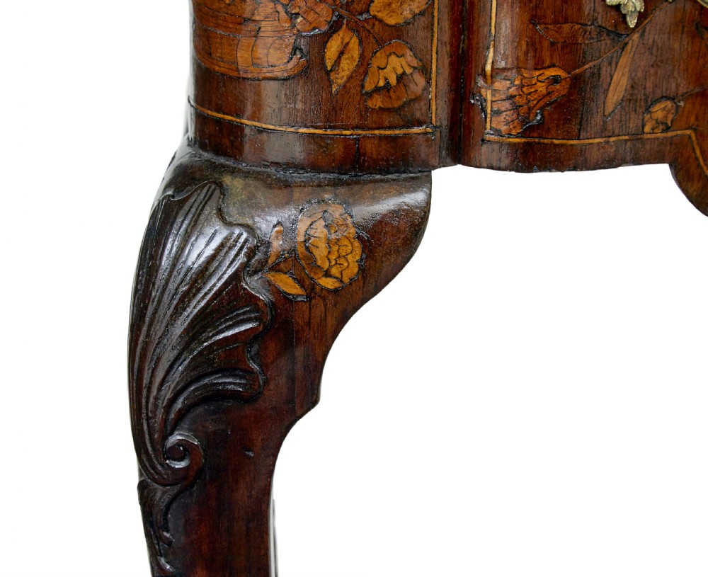 An 18th-century Dutch walnut games table decorated with floral marquetry inlay, carved cabriole legs, and brass drop handles. View XIV