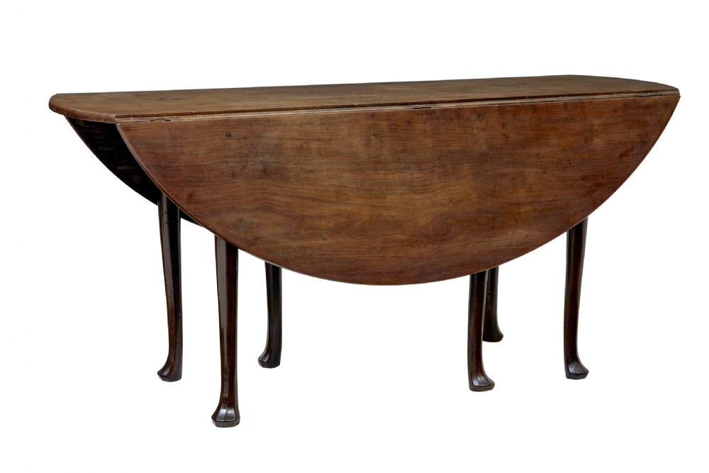An 18th-century Chippendale mahogany drop-leaf gateleg dining table with cabriole legs and pad feet.