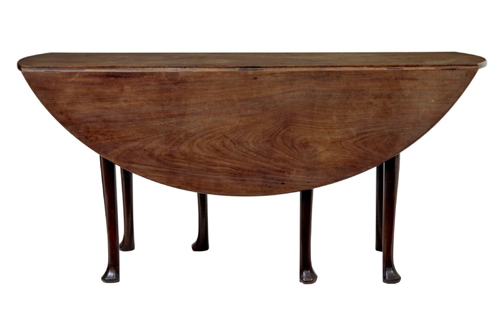 An 18th-century Chippendale mahogany drop-leaf gateleg dining table with cabriole legs and pad feet. View IV