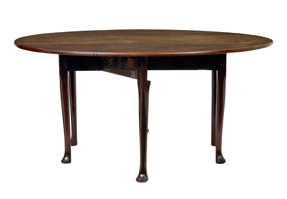 An 18th-century Chippendale mahogany drop-leaf gateleg dining table with cabriole legs and pad feet. View V
