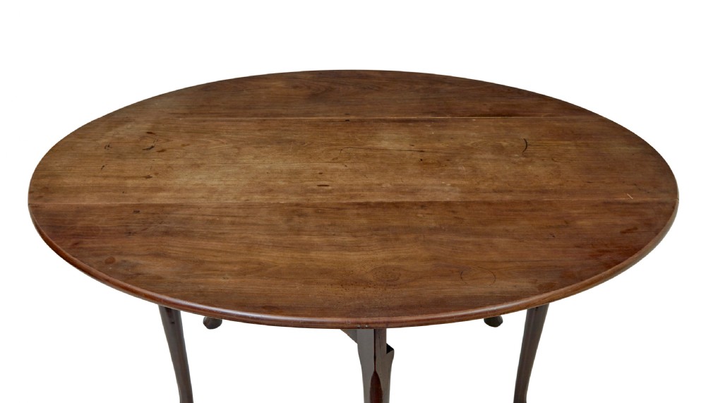 An 18th-century Chippendale mahogany drop-leaf gateleg dining table with cabriole legs and pad feet. View IX