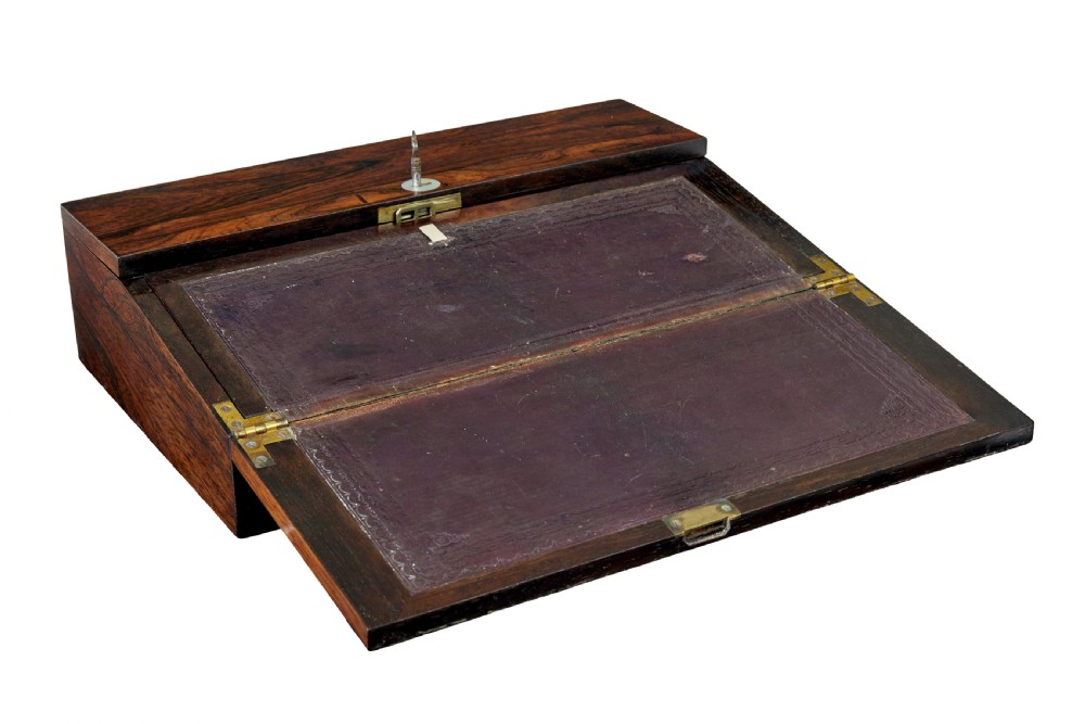A 19th-century William IV figured rosewood writing slope featuring a slanted top, metal key, and an inlaid plaque dated 1835. View II