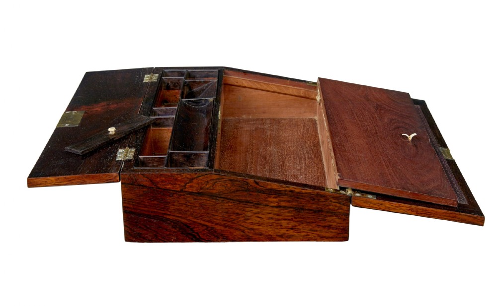 A 19th-century William IV figured rosewood writing slope featuring a slanted top, metal key, and an inlaid plaque dated 1835. View V