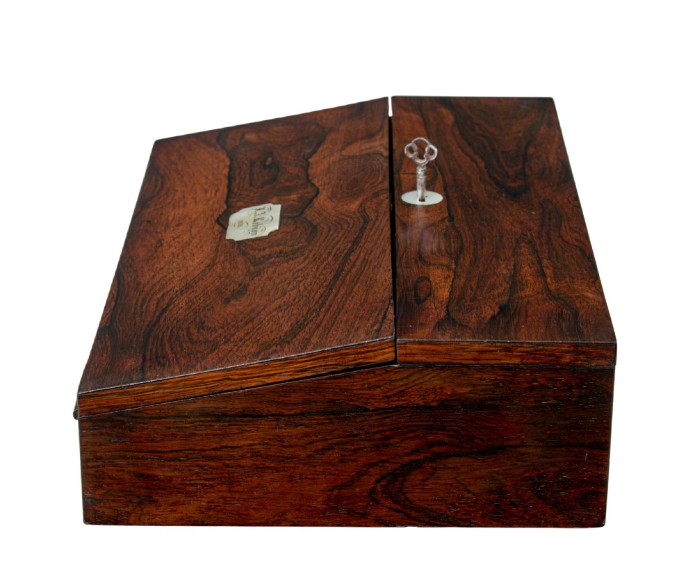 A 19th-century William IV figured rosewood writing slope featuring a slanted top, metal key, and an inlaid plaque dated 1835. View VIII
