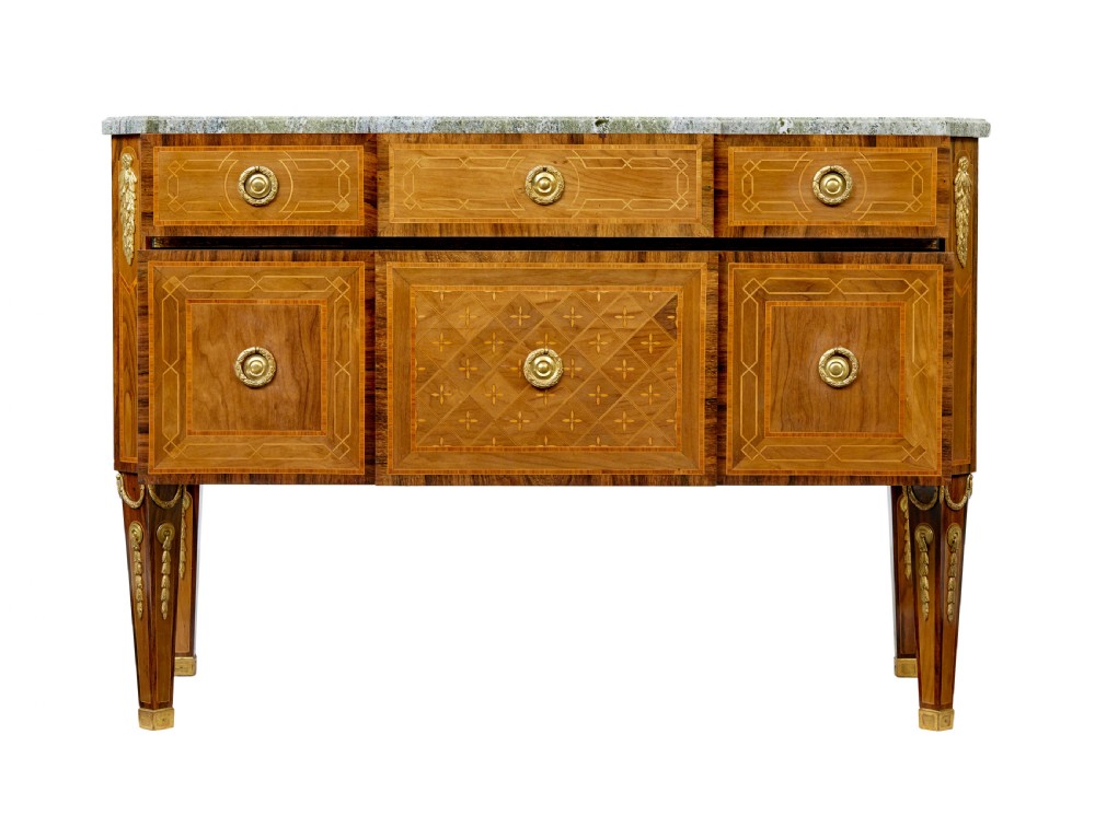 An early 20th-century walnut commode featuring marquetry inlay, gilt bronze mounts, square tapered legs, and a fitted grey marble top. View III