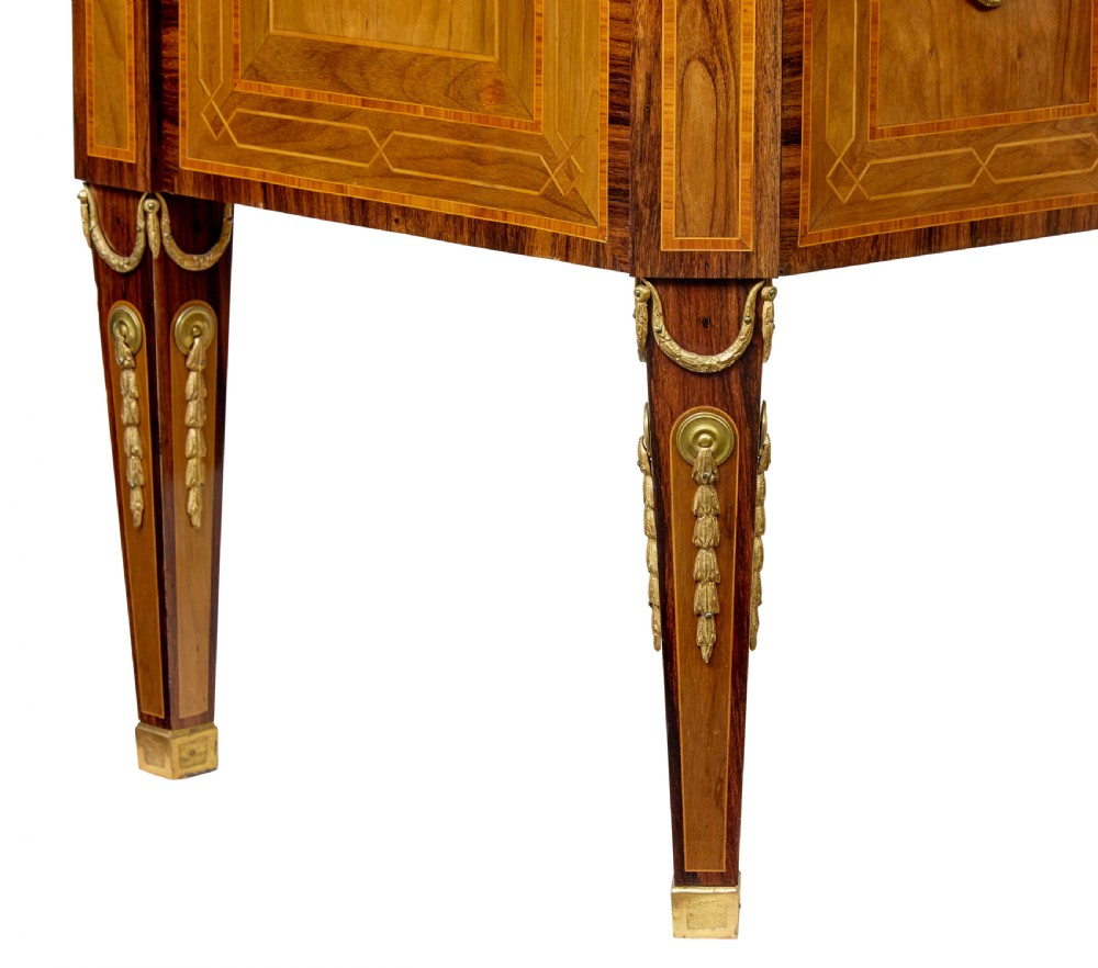 An early 20th-century walnut commode featuring marquetry inlay, gilt bronze mounts, square tapered legs, and a fitted grey marble top. View VIII