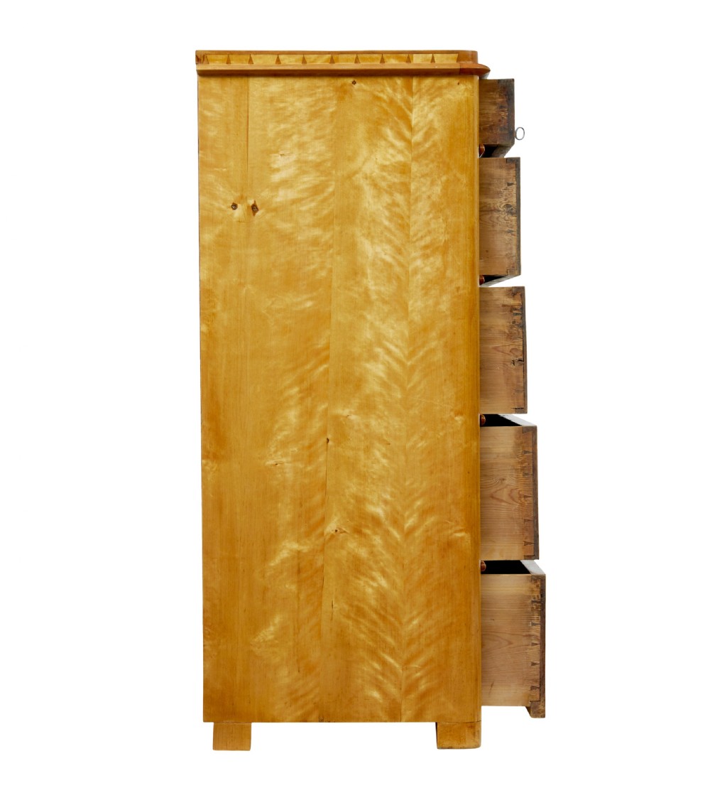 A 19th-century Swedish flame birch chest featuring five graduated drawers with white keyhole escutcheons. View VII