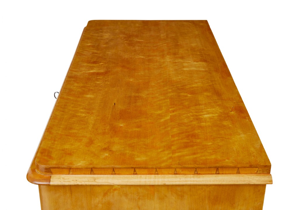 A 19th-century Swedish flame birch chest featuring five graduated drawers with white keyhole escutcheons. View IX