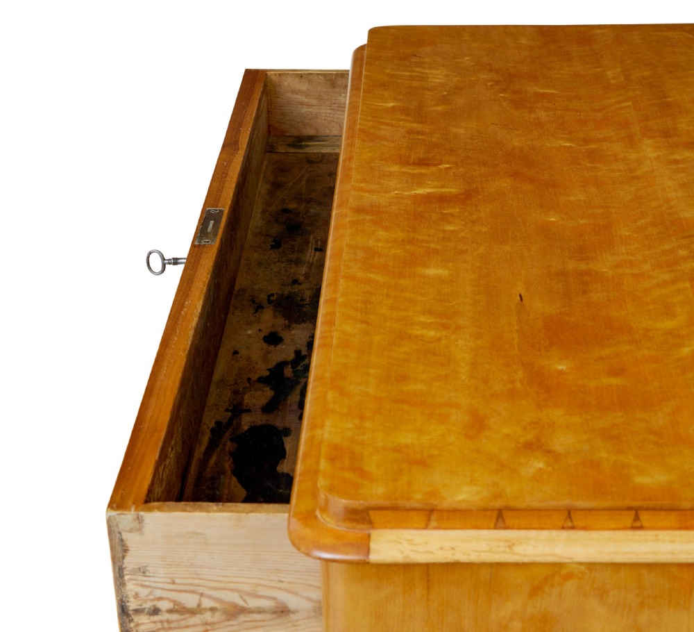 A 19th-century Swedish flame birch chest featuring five graduated drawers with white keyhole escutcheons. View X