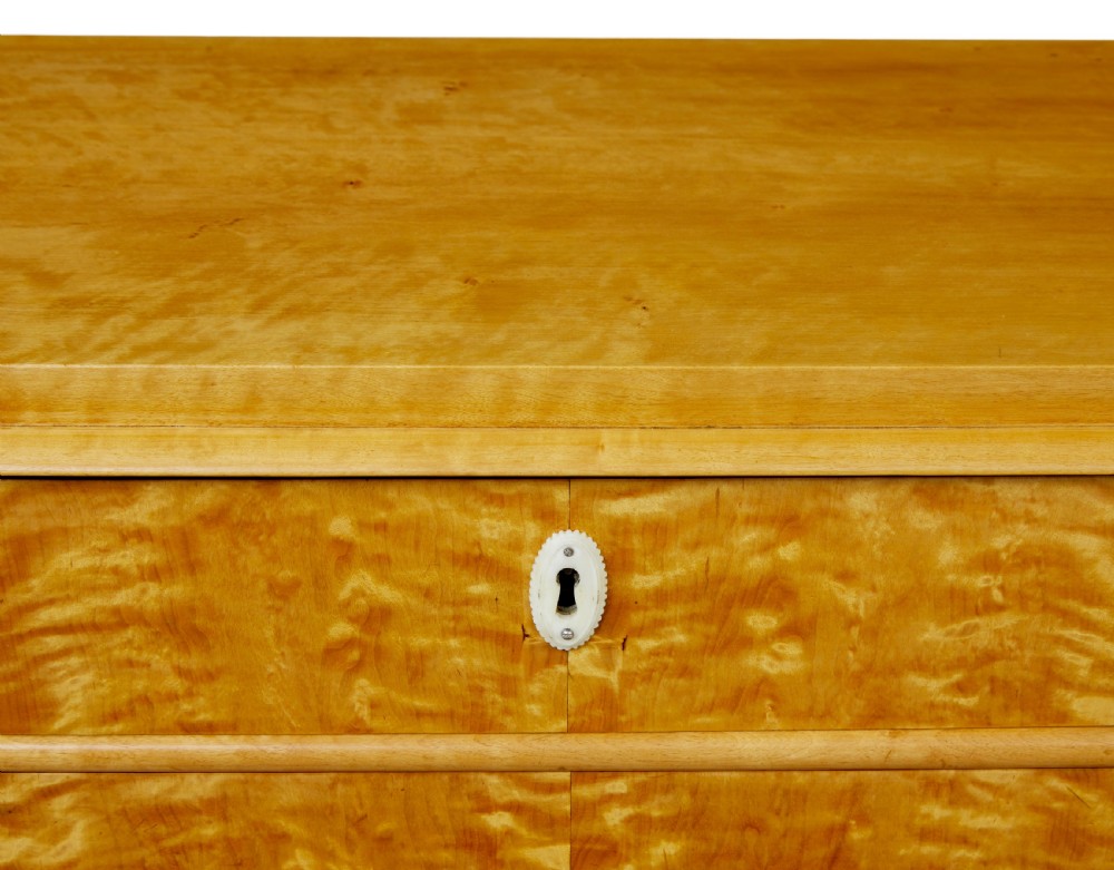 A 19th-century Swedish flame birch chest featuring five graduated drawers with white keyhole escutcheons. View XI