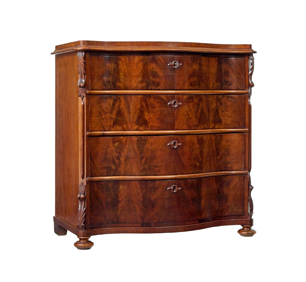 A 19th-century Swedish mahogany chest of drawers with a serpentine front, four drawers, flame timber veneer, carved side accents, and turned feet.