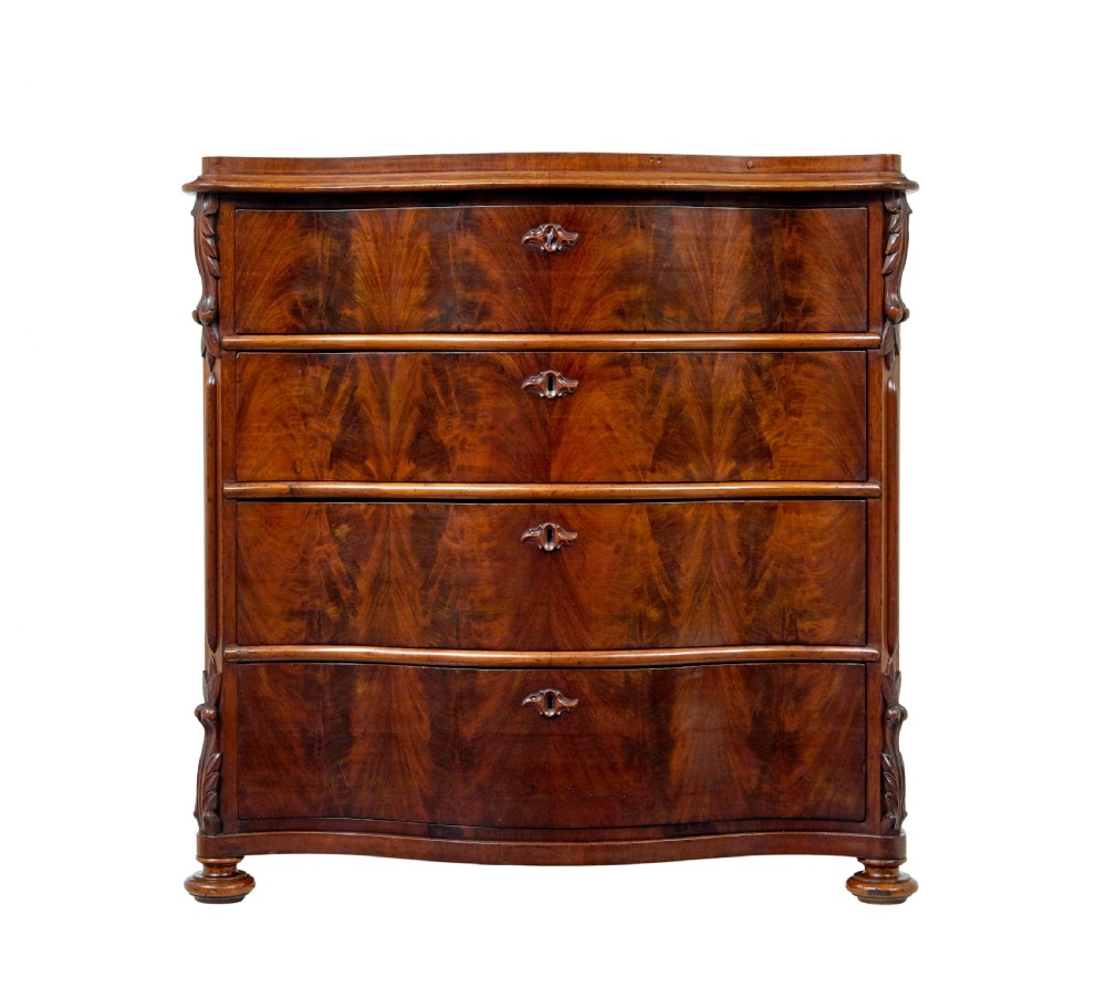 A 19th-century Swedish mahogany chest of drawers with a serpentine front, four drawers, flame timber veneer, carved side accents, and turned feet. View II