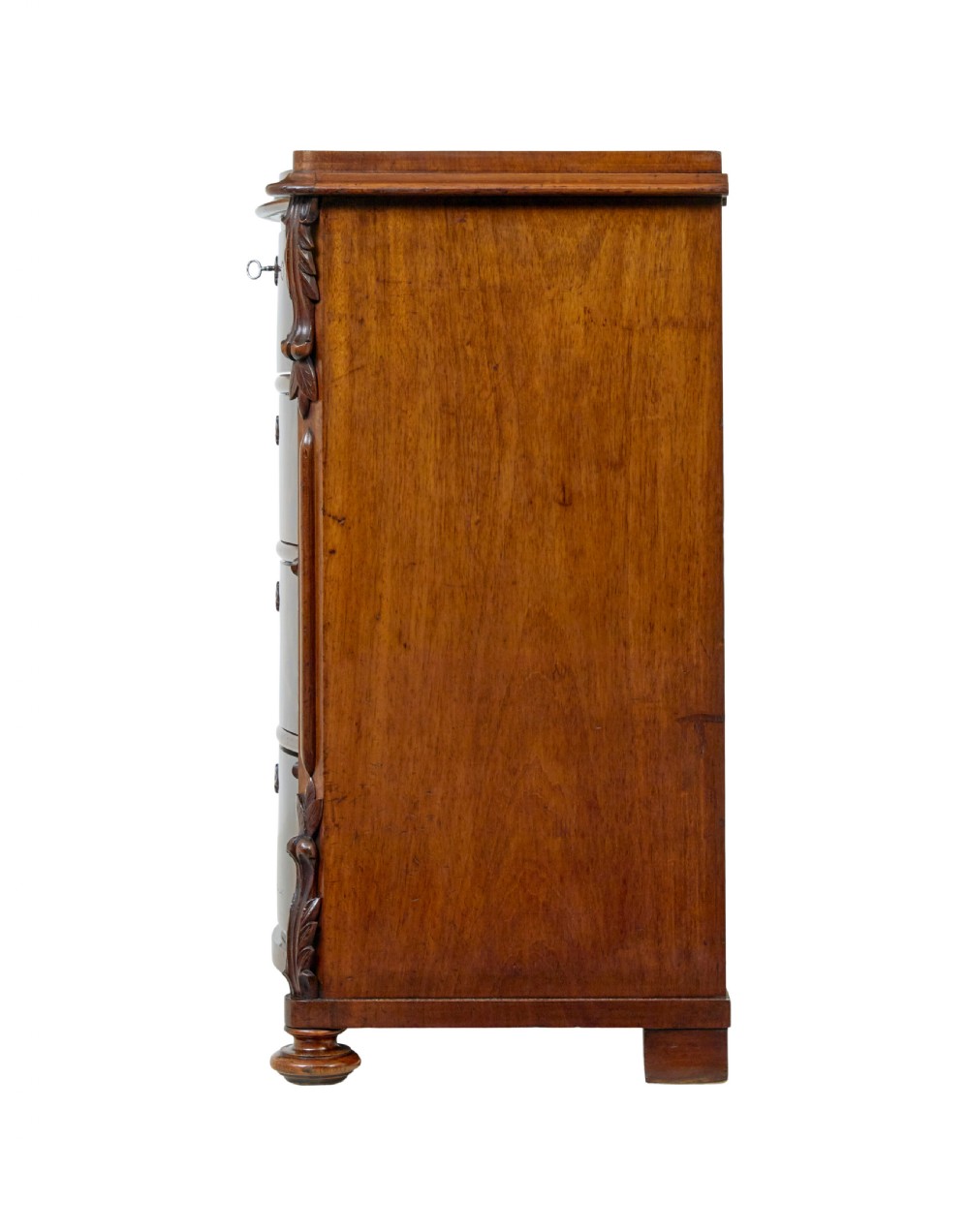A 19th-century Swedish mahogany chest of drawers with a serpentine front, four drawers, flame timber veneer, carved side accents, and turned feet. View VII