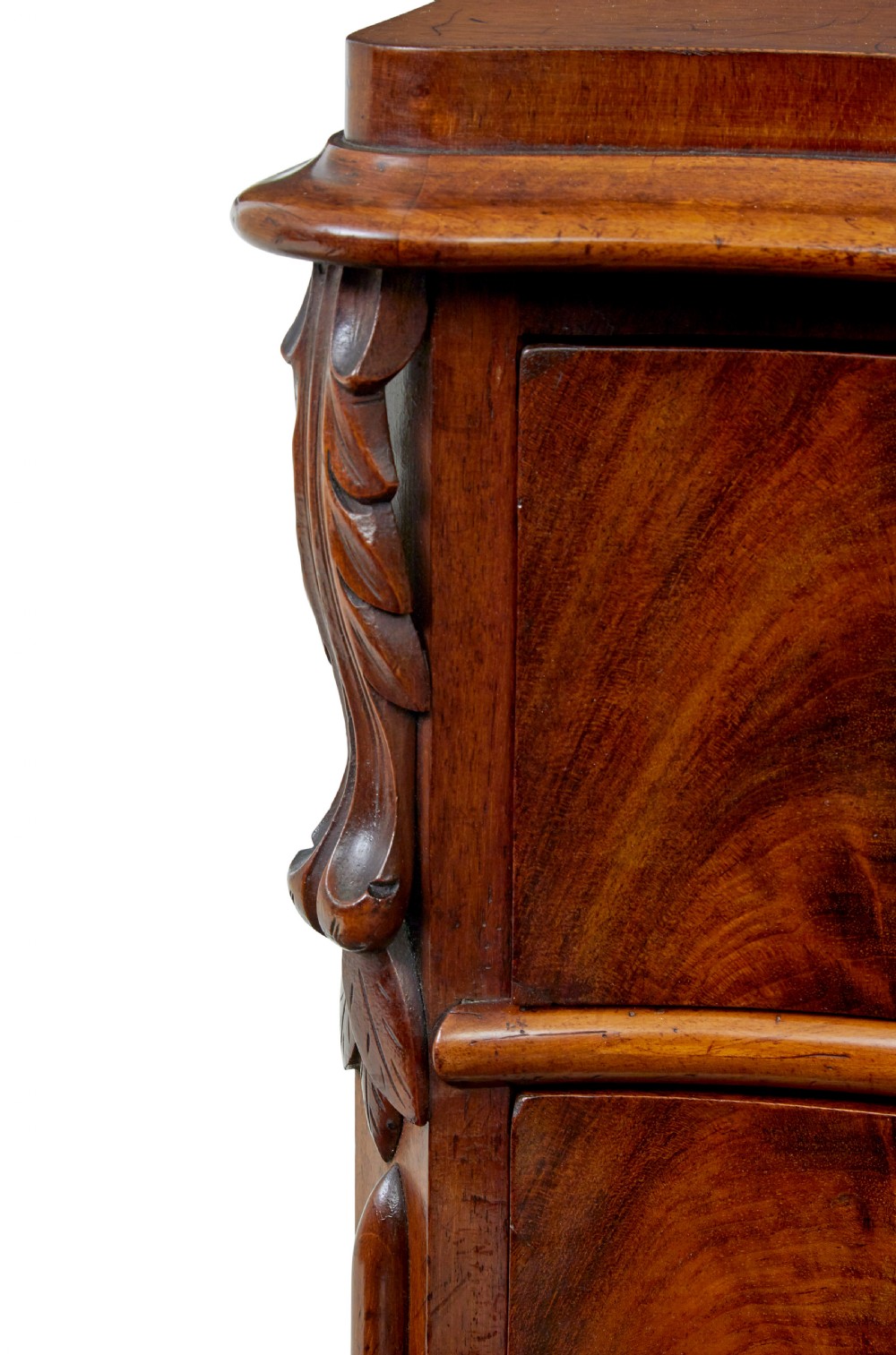 A 19th-century Swedish mahogany chest of drawers with a serpentine front, four drawers, flame timber veneer, carved side accents, and turned feet. View IX