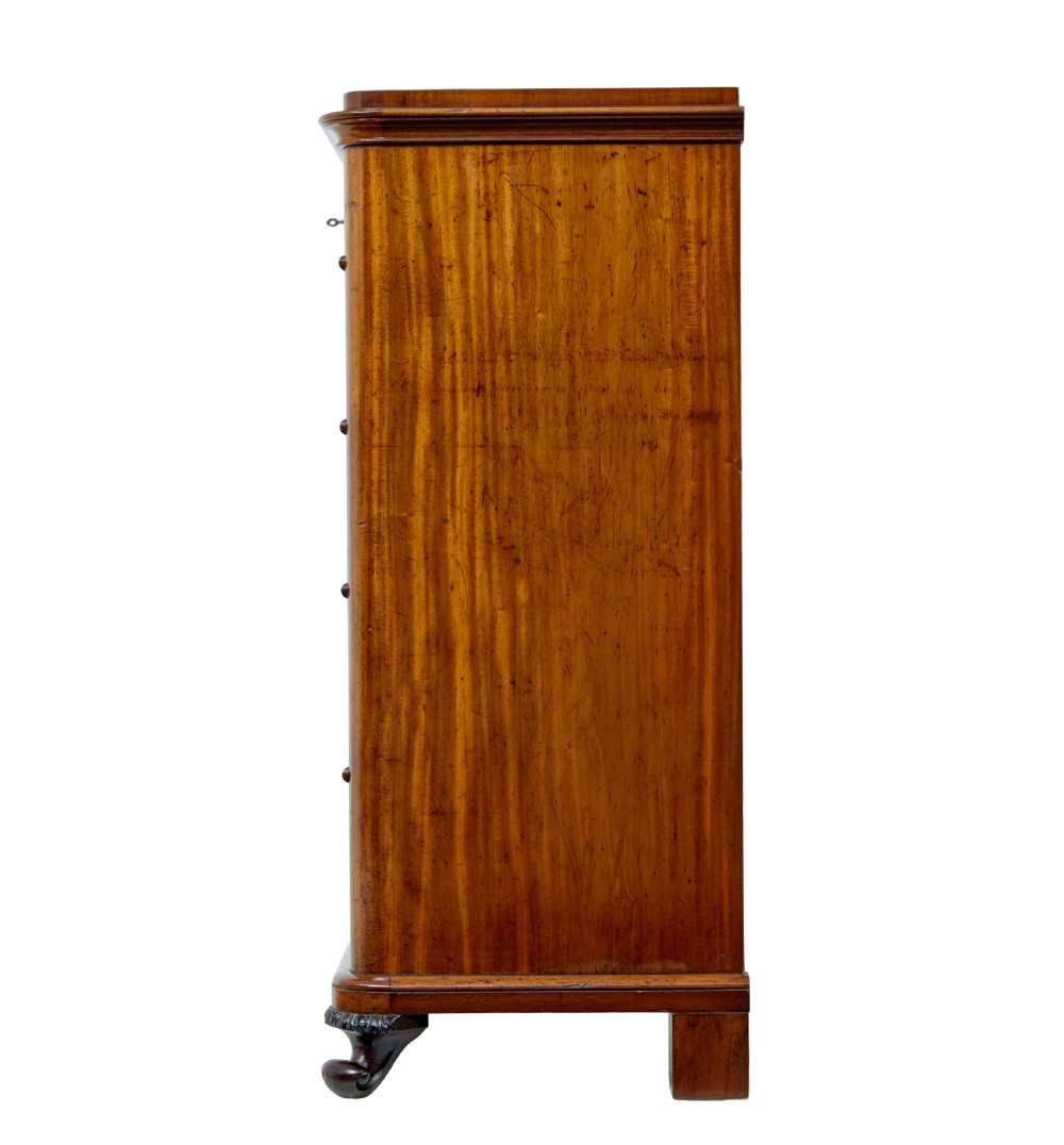 A nineteenth-century Swedish mahogany chest of drawers featuring five stacked drawers with book-matched veneer and brass keyhole escutcheons. View V