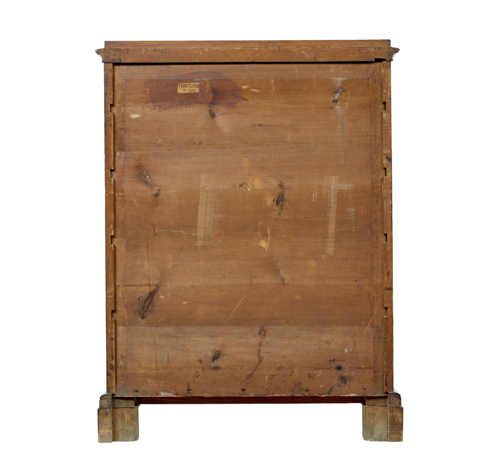 A nineteenth-century Swedish mahogany chest of drawers featuring five stacked drawers with book-matched veneer and brass keyhole escutcheons. View VI