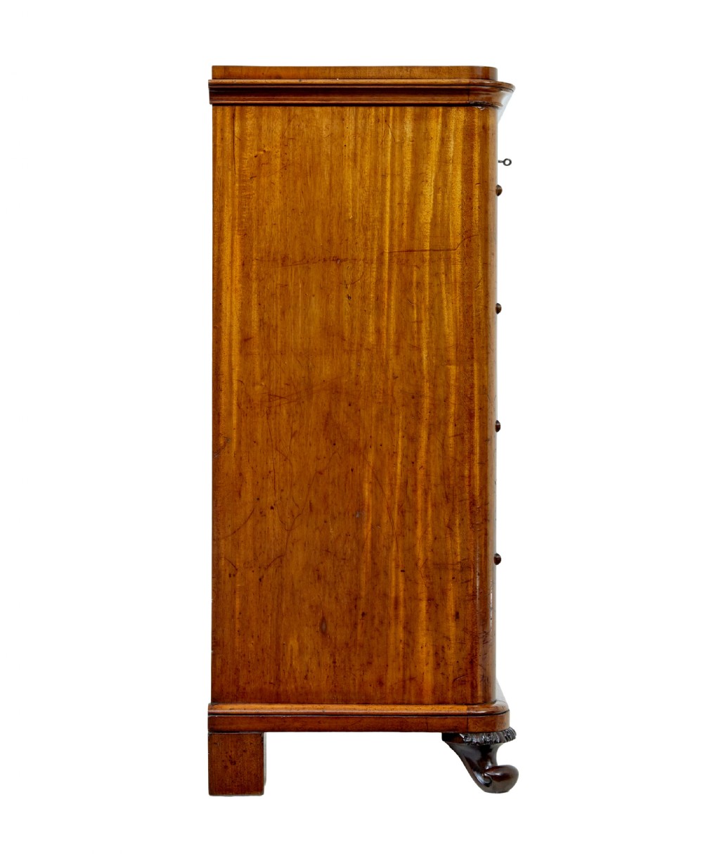 A nineteenth-century Swedish mahogany chest of drawers featuring five stacked drawers with book-matched veneer and brass keyhole escutcheons. View VII