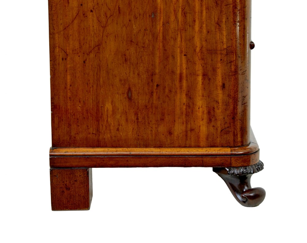 A nineteenth-century Swedish mahogany chest of drawers featuring five stacked drawers with book-matched veneer and brass keyhole escutcheons. View VIII